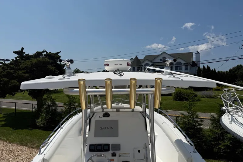 Slide: The Image of 2009 Century 2901 Center Console boat with Garmin equipment and rod holders, under clear blue sky. - 10
