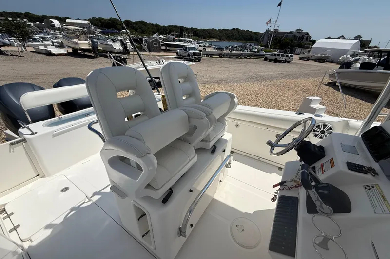 Slide: The Image of 2009 Century 2901 Center Console boat interior with dual seats and steering wheel. - 11