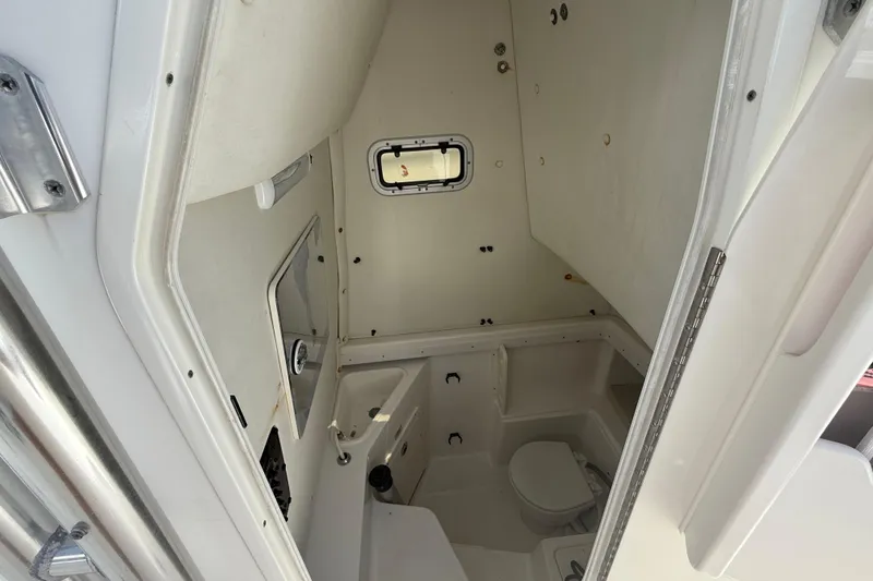 Slide: The Image of 2009 Century 2901 Center Console boat interior with compact bathroom amenities. - 13