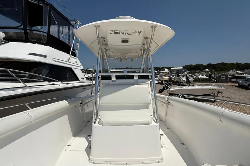 Slide: The Image of 2009 Century 2901 Center Console boat docked at a marina under clear blue skies. - 14