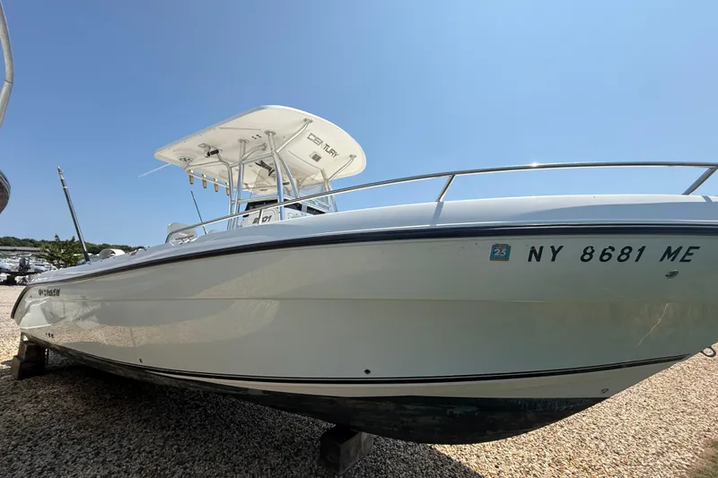 Slide: The Image of 2009 Century 2901 Center Console boat on gravel, clear sky background. - 17