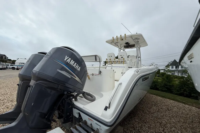 Slide: The Image of 2009 Century 2901 Center Console boat with Yamaha engines on a gravel lot. - 2