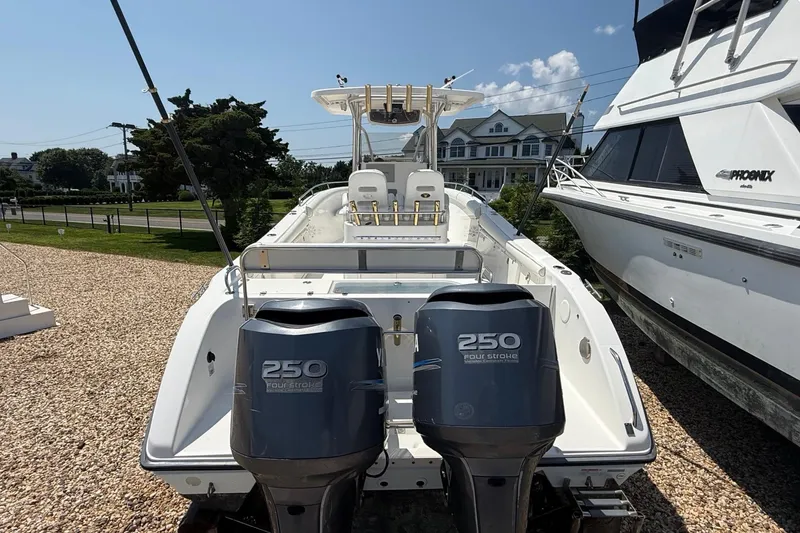 Slide: The Image of 2009 Century 2901 Center Console boat with dual 250 horsepower engines, docked outdoors. - 5