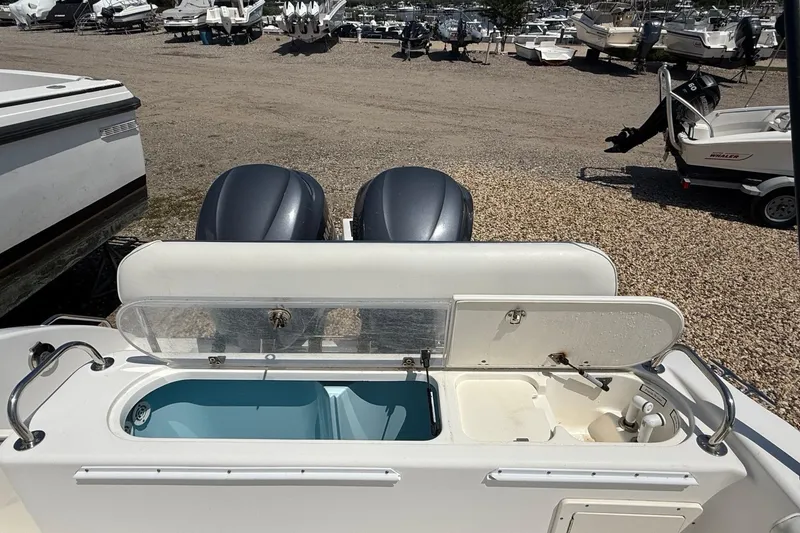 Slide: The Image of 2009 Century 2901 Center Console boat with open storage compartments and dual engines. - 8