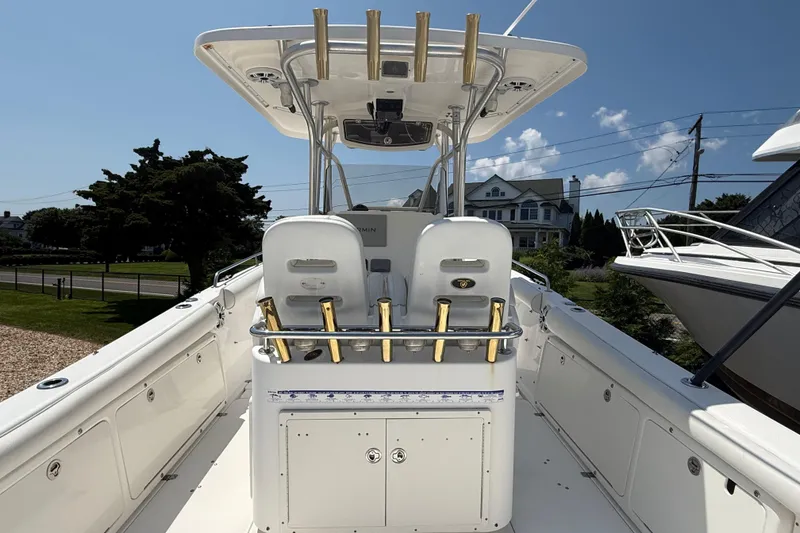 Slide: The Image of 2009 Century 2901 Center Console boat with rod holders and helm station, docked outdoors. - 9