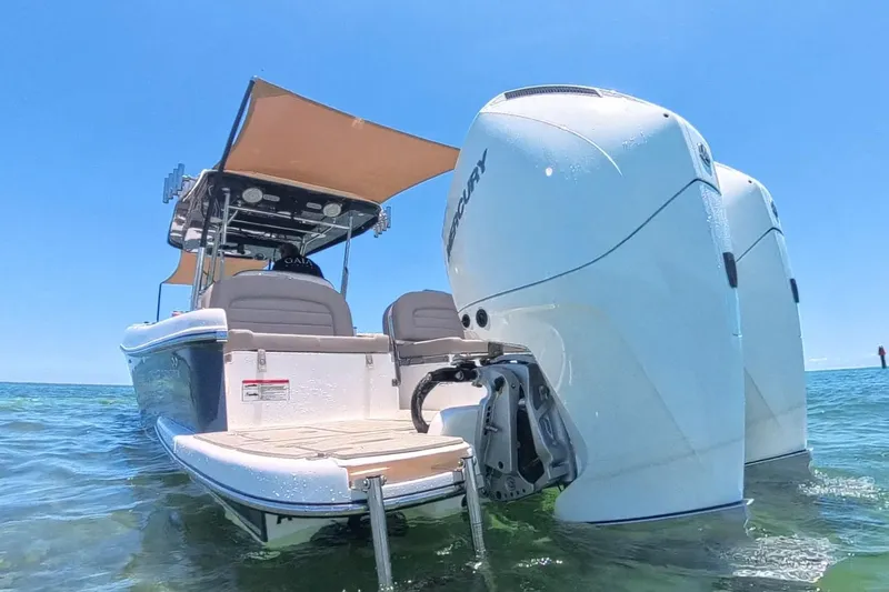 Slide: The Image of 2024 Victory Yachts V300 with dual Mercury engines on clear blue water. - 10