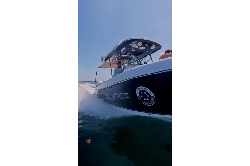 Slide: The Image of 2024 Victory Yachts V300 cruising on open water, showcasing sleek design and performance. - 14