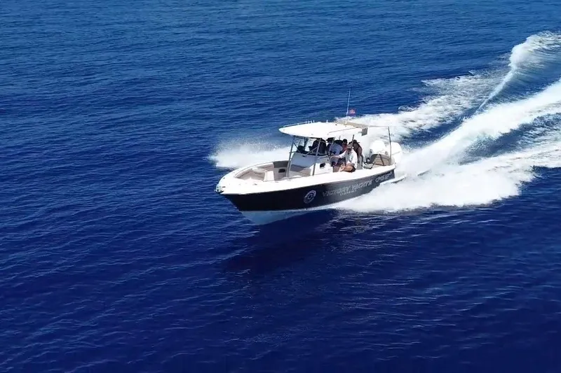 Slide: The Image of 2024 Victory Yachts V300 cruising on open blue ocean waters. - 2