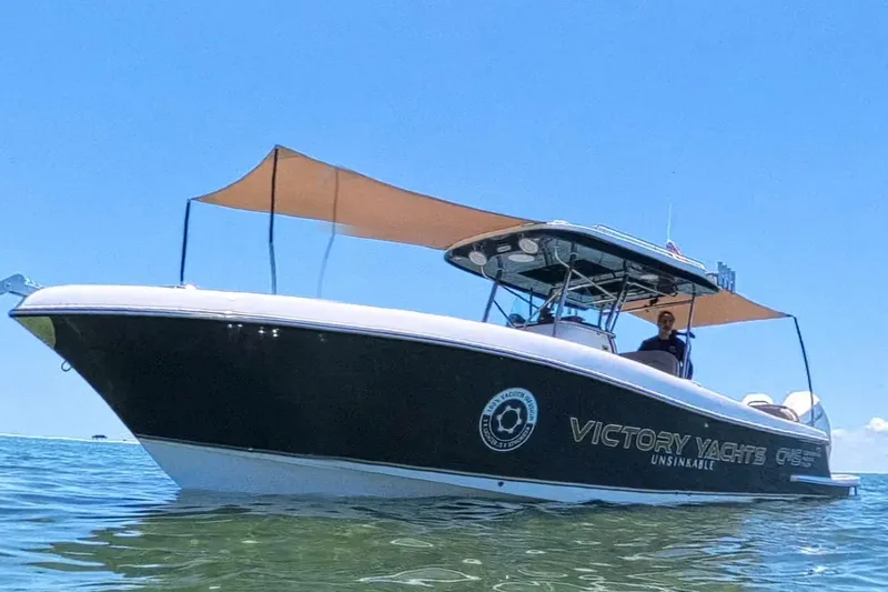 Slide: The Image of 2024 Victory Yachts V300 boat on water, featuring sleek design and sunshade canopy. - 3