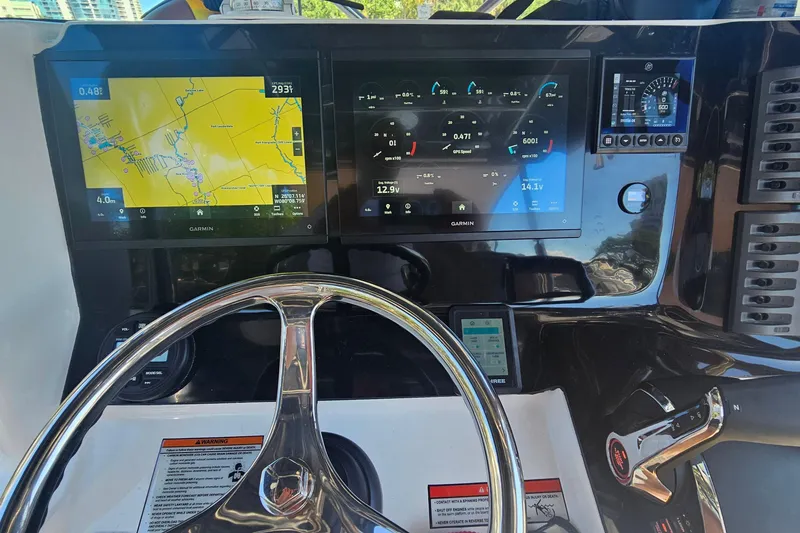 Slide: The Image of Helm of 2024 Victory Yachts V300 featuring advanced Garmin navigation displays. - 4