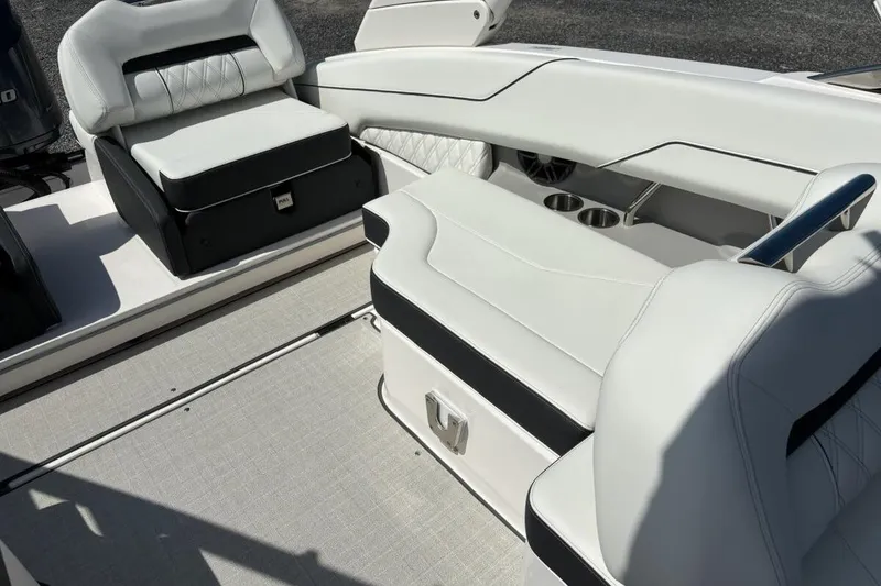 Slide: The Image of 2023 Regal LX4 boat interior with white leather seating and cup holders. - 12