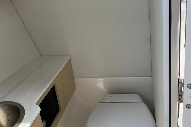 Slide: The Image of 2023 Regal LX4 boat interior bathroom with sink and toilet. - 14