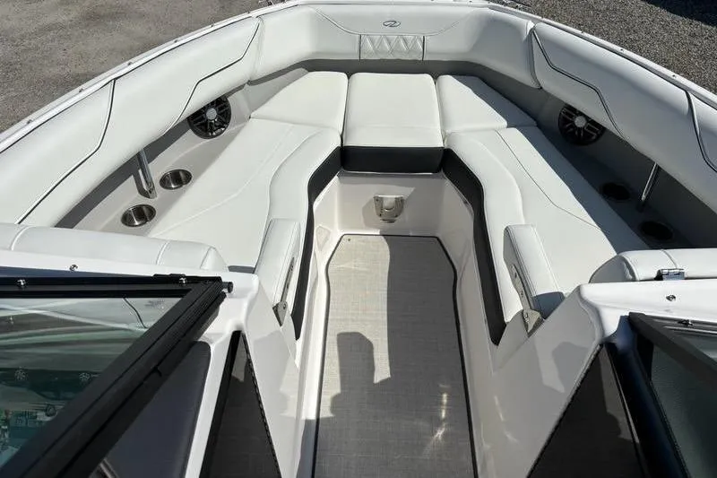 Slide: The Image of 2023 Regal LX4 boat interior with white seating and cup holders. - 2