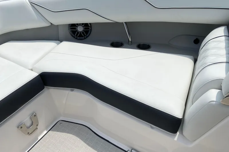 Slide: The Image of 2023 Regal LX4 boat interior with white cushioned seating and cup holders. - 3