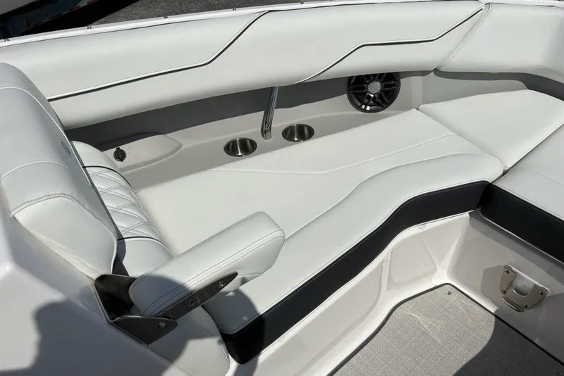 Slide: The Image of 2023 Regal LX4 boat interior with white leather seating and cup holders. - 4