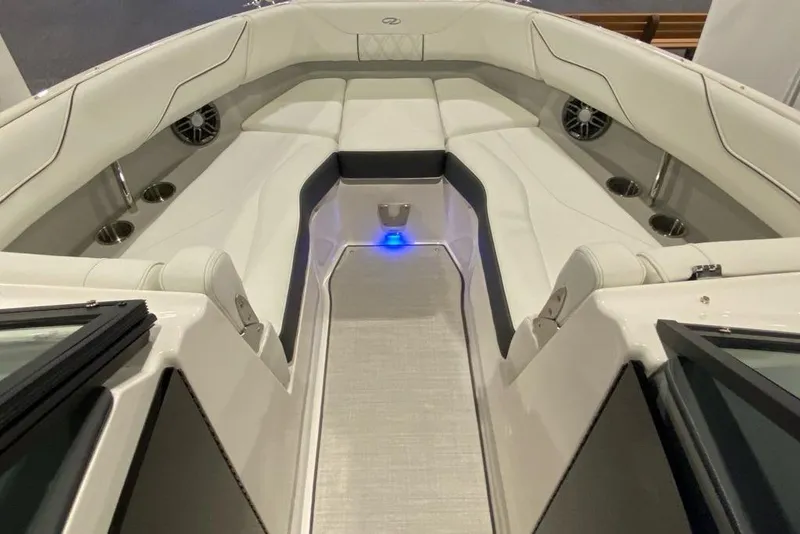 Slide: The Image of 2023 Regal LX4 boat interior with white seating and cup holders. - 7