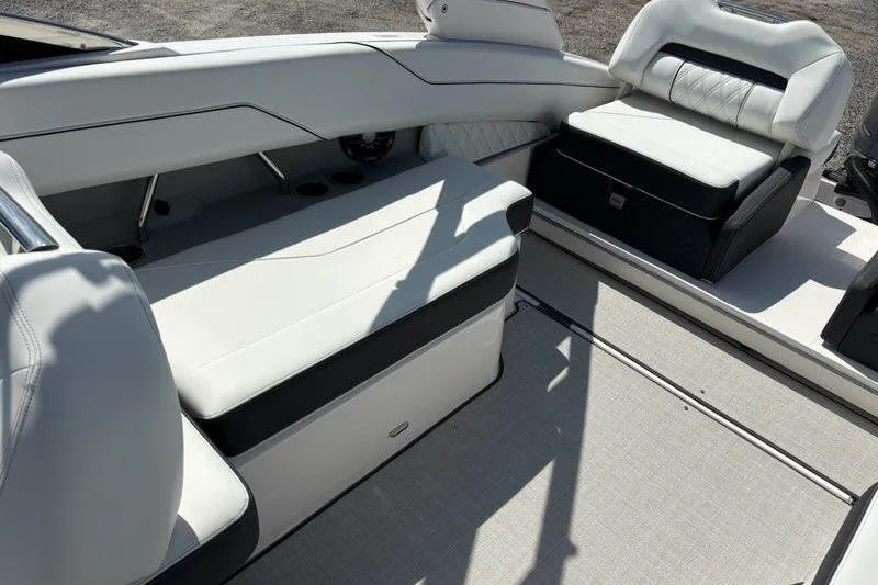 Slide: The Image of 2023 Regal LX4 boat interior with white and black seating, modern design. - 8