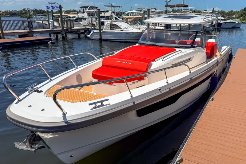 The Image of 2025 Nimbus Tender 11 boat docked at marina with vibrant red seating. - 0