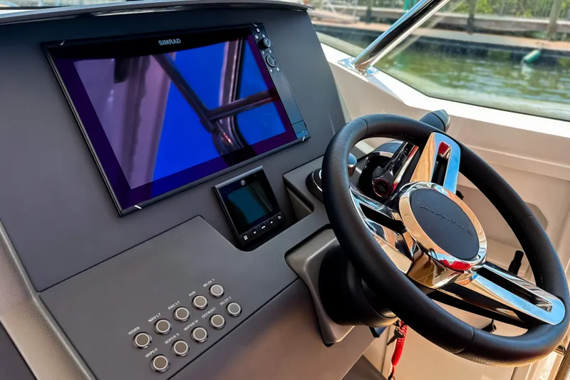 Slide: The Image of Steering console of 2025 Nimbus Tender 11 with modern controls and navigation display. - 14