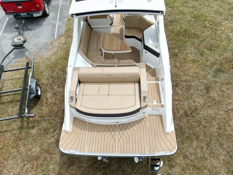 Slide: The Image of 2022 Sea Ray SLX 310 boat with tan seating and wooden deck, aerial view. - 13