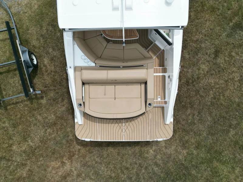 Slide: The Image of Overhead view of 2022 Sea Ray SLX 310 boat with beige seating and wooden deck. - 14
