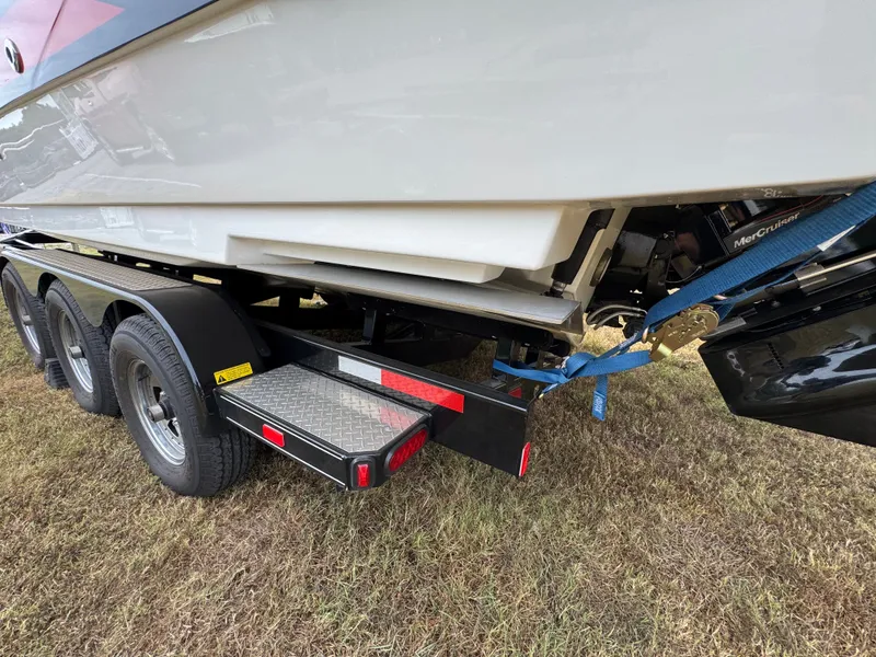 Slide: The Image of 2022 Sea Ray SLX 310 boat on a trailer, secured with blue straps. - 15