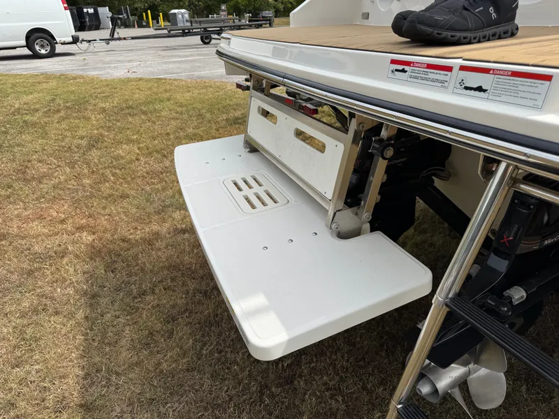 Slide: The Image of 2022 Sea Ray SLX 310 swim platform with ladder, parked on grass. - 16