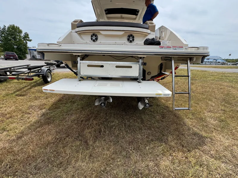 Slide: The Image of 2022 Sea Ray SLX 310 boat rear view with swim platform and ladder. - 17