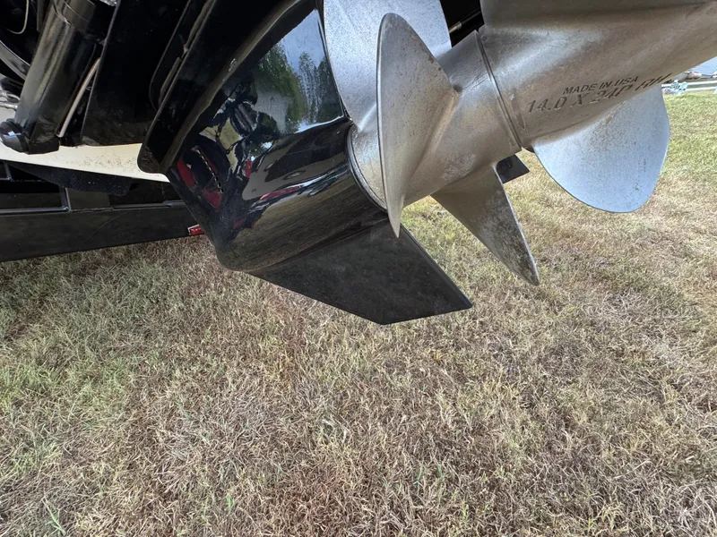 Slide: The Image of Close-up of a 2022 Sea Ray SLX 310 boat propeller on grass. - 22