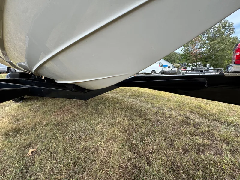 Slide: The Image of 2022 Sea Ray SLX 310 boat on trailer, grassy area, side view. - 31