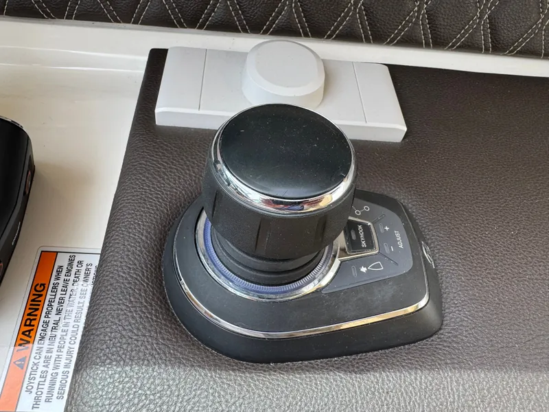Slide: The Image of Joystick control on 2022 Sea Ray SLX 310 boat dashboard. - 35