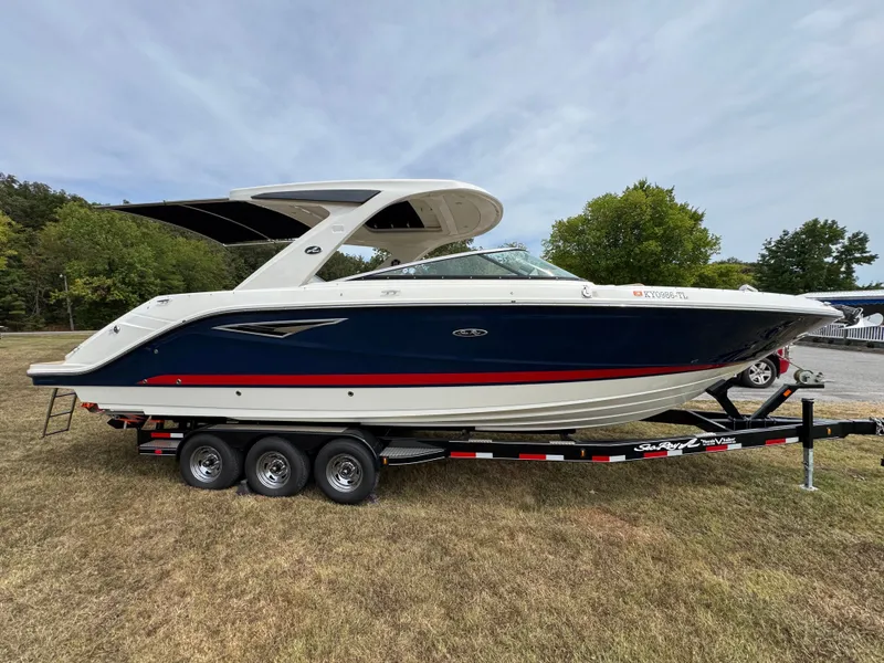 Slide: The Image of 2022 Sea Ray SLX 310 boat on trailer, parked on grass, side view. - 4