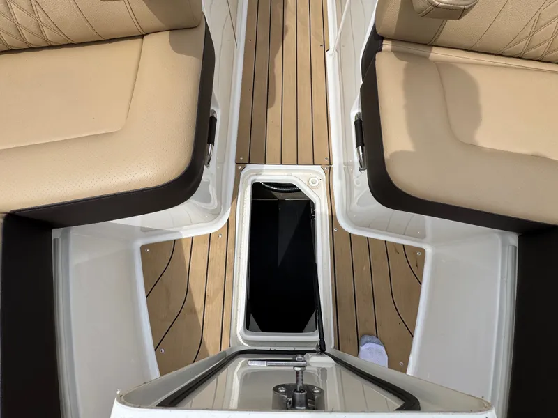 Slide: The Image of 2022 Sea Ray SLX 310 interior with tan seating and wood-style flooring. - 45