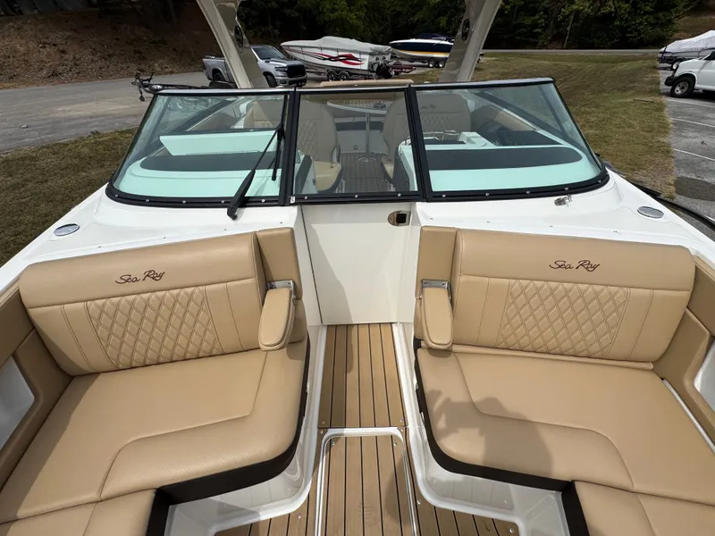 Slide: The Image of 2022 Sea Ray SLX 310 boat interior with tan leather seating and wood flooring. - 46