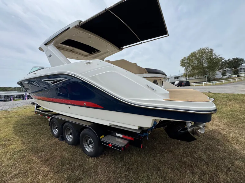 Slide: The Image of 2022 Sea Ray SLX 310 boat on trailer, displayed outdoors on grass. - 6