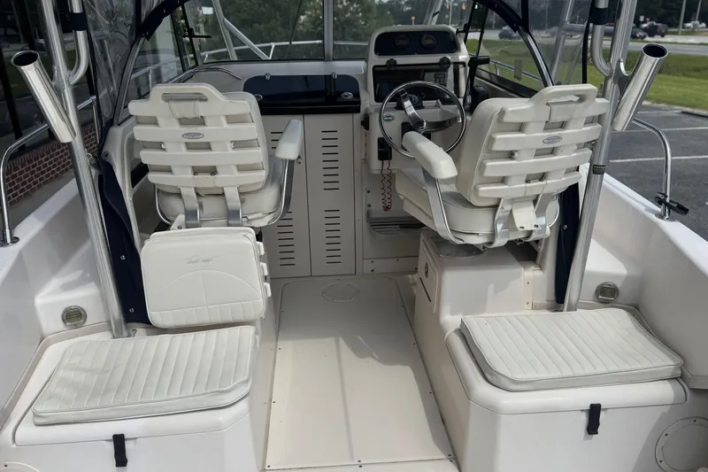 Slide: The Image of 2005 Grady-White Seafarer 228 boat interior with helm and seating area. - 11