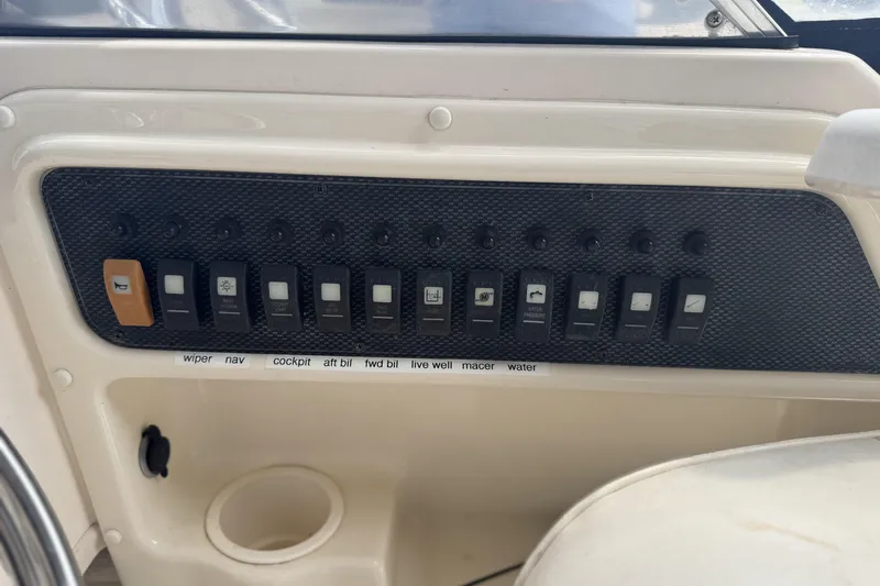 Slide: The Image of Control panel of a 2005 Grady-White Seafarer 228 boat with labeled switches. - 12