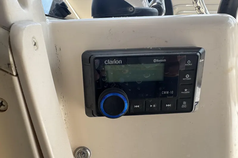 Slide: The Image of Clarion CMM-10 Bluetooth stereo on 2005 Grady-White Seafarer 228 boat dashboard. - 13