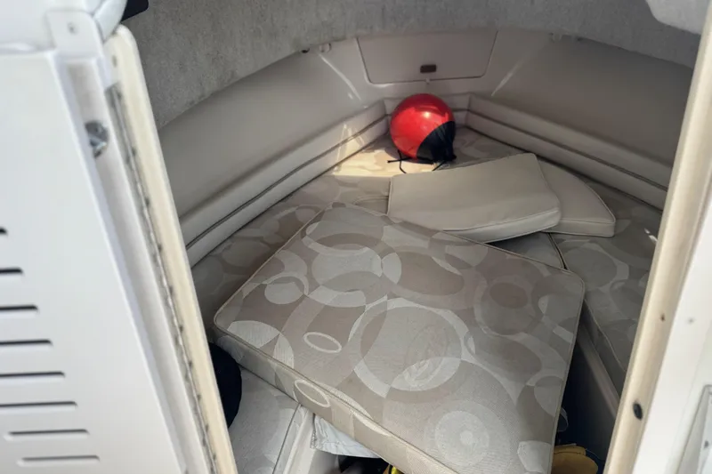 Slide: The Image of 2005 Grady-White Seafarer 228 cabin interior with cushions and a red buoy. - 14
