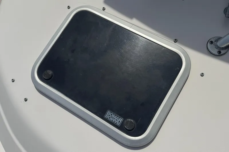 Slide: The Image of Deck hatch on 2005 Grady-White Seafarer 228 boat, featuring a black cover. - 18