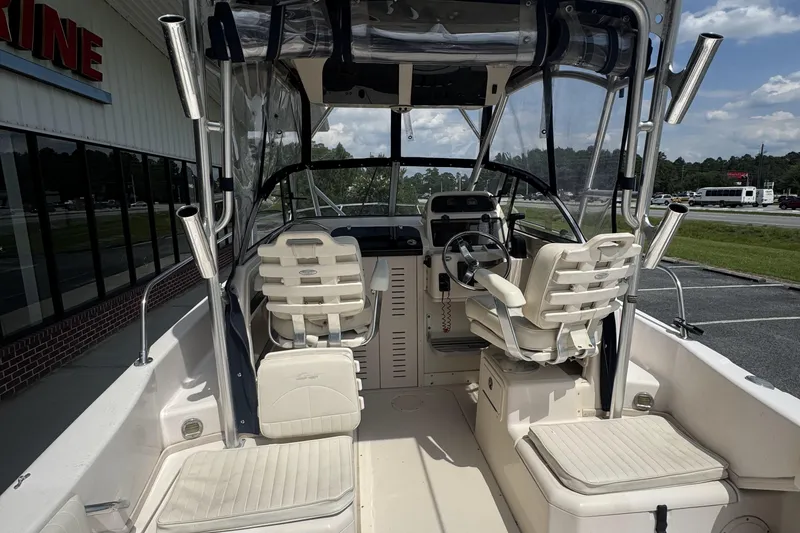 Slide: The Image of 2005 Grady-White Seafarer 228 boat interior with helm and seating, parked outdoors. - 21