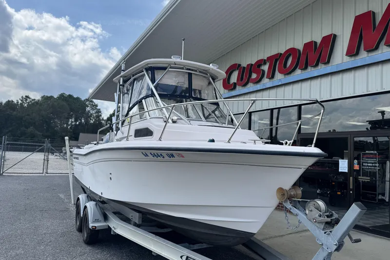 Slide: The Image of 2005 Grady-White Seafarer 228 boat on trailer outside Custom Marine shop. - 3