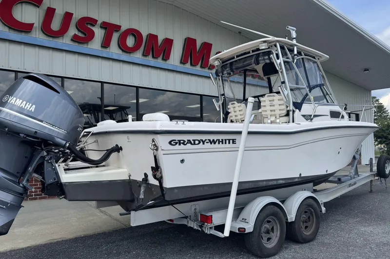 Slide: The Image of 2005 Grady-White Seafarer 228 boat on trailer, Yamaha engine, parked outside dealership. - 4