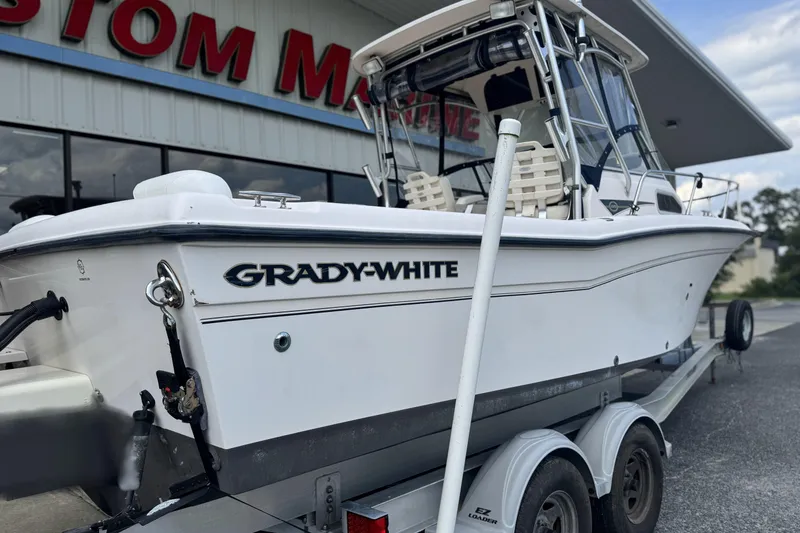 Slide: The Image of 2005 Grady-White Seafarer 228 boat on trailer outside a marine store. - 5