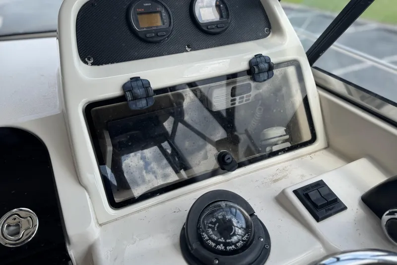 Slide: The Image of 2005 Grady-White Seafarer 228 dashboard with compass and instrument panel. - 7