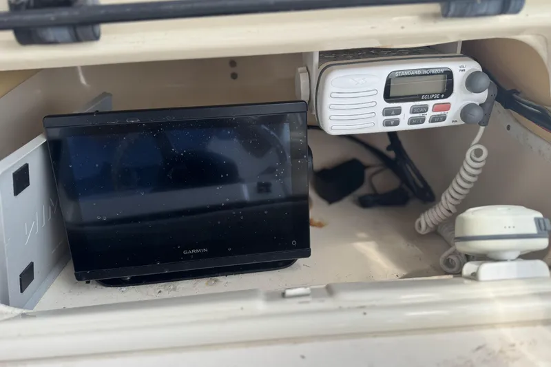 Slide: The Image of 2005 Grady-White Seafarer 228 boat dashboard with Garmin display and radio equipment. - 9