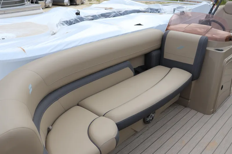 Slide: The Image of 2024 Starcraft 24 EX QDH boat interior with beige and gray seating. - 2