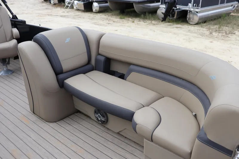 Slide: The Image of 2024 Starcraft 24 EX QDH boat interior with beige and gray seating on deck. - 3