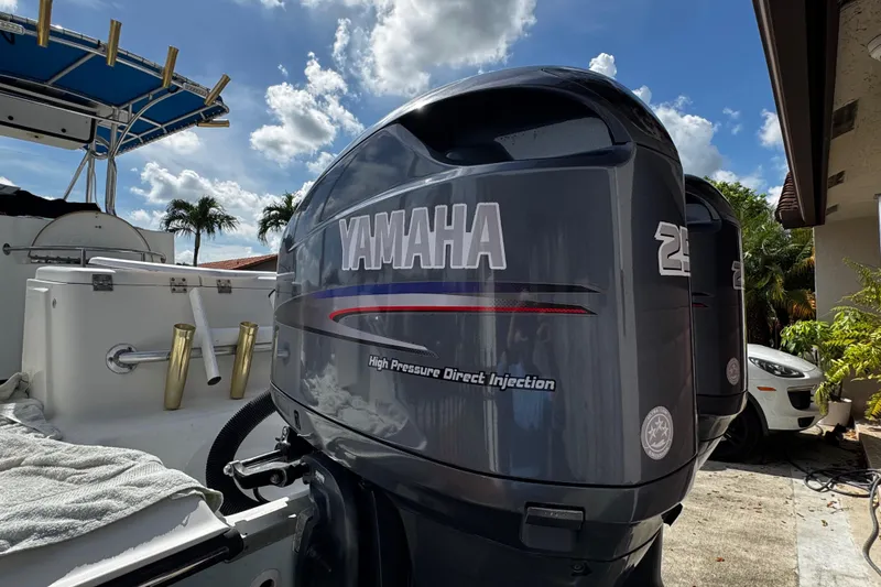 Slide: The Image of 2003 Triton 2895 CC boat with Yamaha outboard motor, parked outdoors. - 14