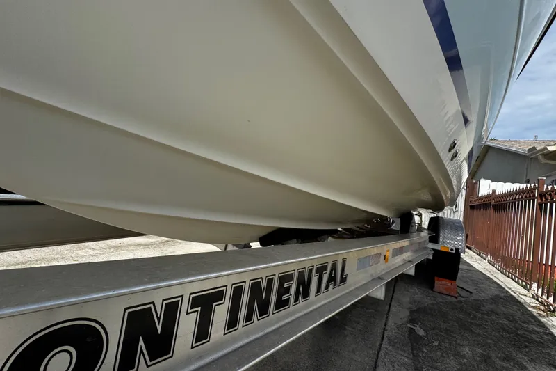 Slide: The Image of 2003 Triton 2895 CC boat on Continental trailer, side view. - 16